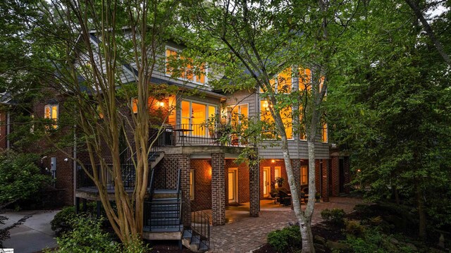 201 King Eider Way, Taylors, SC 29687 - rear view of house featuring brick siding, stairway, and a patio