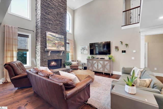 100 Bent Willow Way, Easley, SC 29642 - living area with a high ceiling, a stone fireplace, baseboards, dark wood-style flooring, and ornamental molding