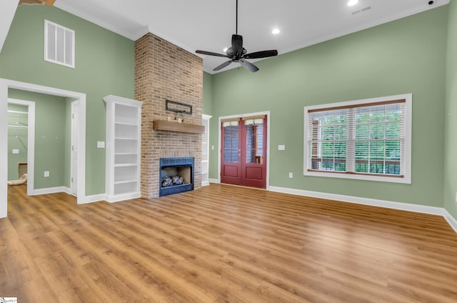 130 Windjammer Way, Anderson, SC 29626 - unfurnished living room featuring a high ceiling, light wood-style floors, baseboards, a brick fireplace, and crown molding