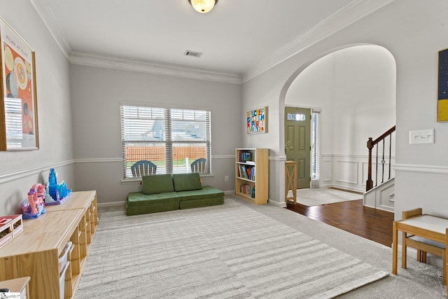 706 Airdale Ln, Simpsonville, SC 29680 - living area with carpet flooring, arched walkways, ornamental molding, and stairs