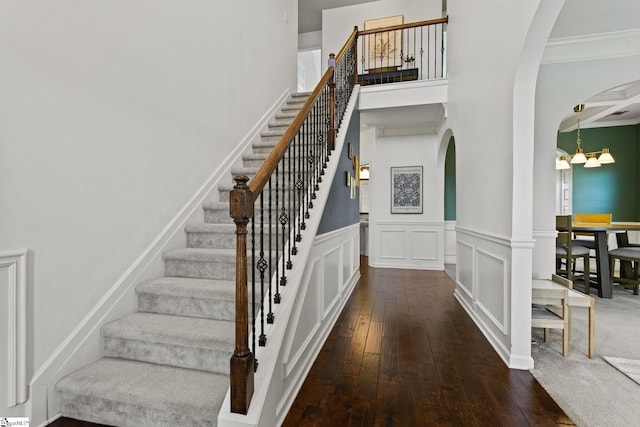 706 Airdale Ln, Simpsonville, SC 29680 - stairs featuring arched walkways, hardwood / wood-style flooring, ornamental molding, a chandelier, and a wainscoted wall