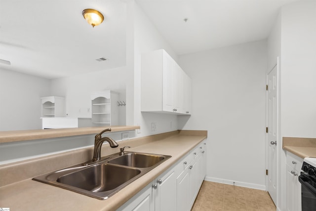 622 Mckenna Cir, Greenville, SC 29615 - kitchen with a sink, range, white cabinetry, baseboards, and light countertops