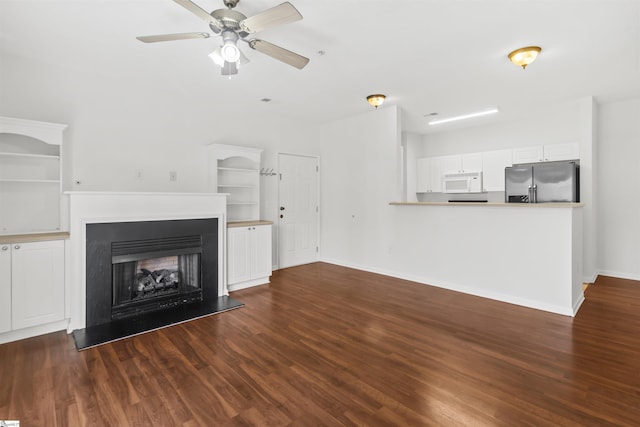 622 Mckenna Cir, Greenville, SC 29615 - unfurnished living room with wood finished floors, a ceiling fan, a multi sided fireplace, and baseboards