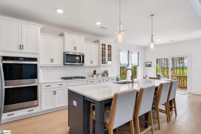 139 Ridgeline Row, Central, SC 29630 - kitchen with appliances with stainless steel finishes, a sink, backsplash, a breakfast bar, and a center island with sink