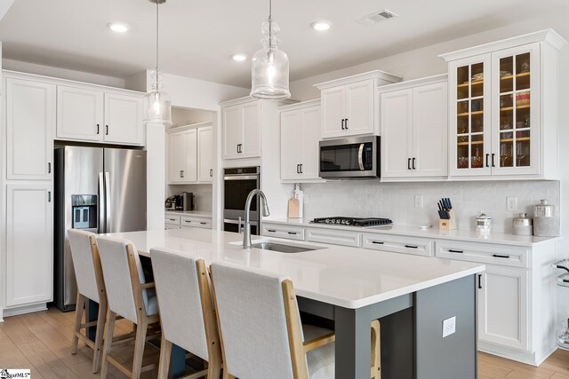 139 Ridgeline Row, Central, SC 29630 - kitchen featuring appliances with stainless steel finishes, a sink, a kitchen island with sink, white cabinetry, and recessed lighting