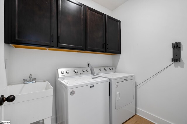 139 Ridgeline Row, Central, SC 29630 - clothes washing area featuring cabinet space, washing machine and dryer, baseboards, and light wood-style flooring