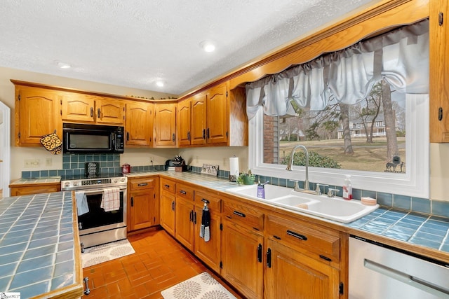 416 Ashley Downs, Anderson, SC 29621 - kitchen featuring tile countertops, appliances with stainless steel finishes, a sink, backsplash, and a textured ceiling
