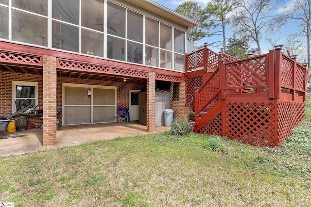 416 Ashley Downs, Anderson, SC 29621 - rear view of house with an attached garage, brick siding, a sunroom, and a lawn