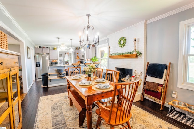 147 Daniel Dr, Easley, SC 29642 - dining space with dark wood-style floors, healthy amount of natural light, a fireplace, and crown molding