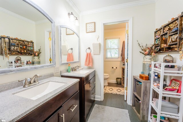 147 Daniel Dr, Easley, SC 29642 - full bathroom featuring ornamental molding, wood finished floors, toilet, two vanities, and baseboards