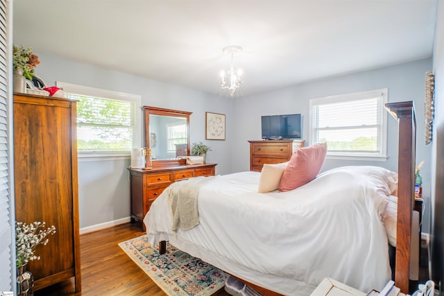 147 Daniel Dr, Easley, SC 29642 - bedroom with wood finished floors, a chandelier, and baseboards