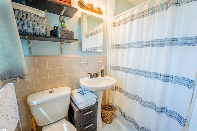 147 Daniel Dr, Easley, SC 29642 - bathroom with tile walls, toilet, curtained shower, wainscoting, and a sink