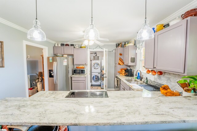 147 Daniel Dr, Easley, SC 29642 - kitchen with stainless steel appliances, stacked washer and clothes dryer, a sink, ornamental molding, and ceiling fan