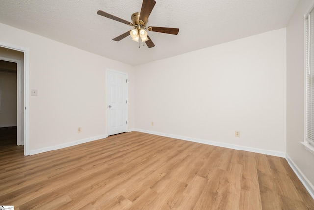 unfurnished bedroom featuring light wood-style floors, baseboards, ceiling fan, and a textured ceiling