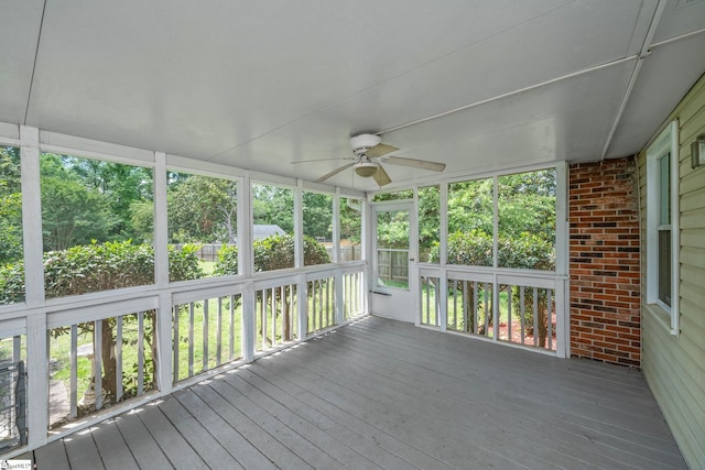 unfurnished sunroom with a ceiling fan