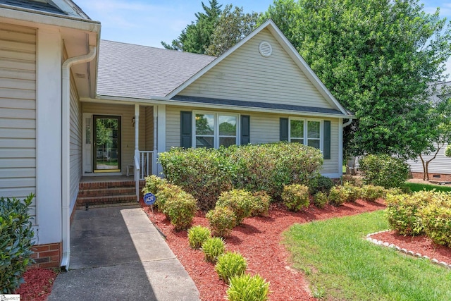 property entrance with a shingled roof