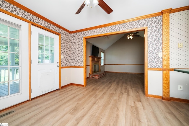 unfurnished room with ceiling fan, wallpapered walls, wood finished floors, baseboards, and ornamental molding