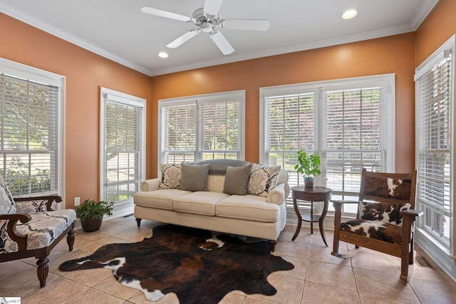 living area with healthy amount of natural light, light tile patterned floors, recessed lighting, and crown molding
