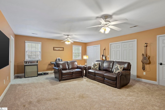 living room featuring ceiling fan, carpet flooring, and baseboards