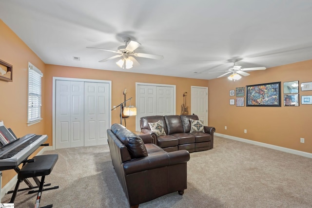 living area with a ceiling fan, carpet floors, and baseboards
