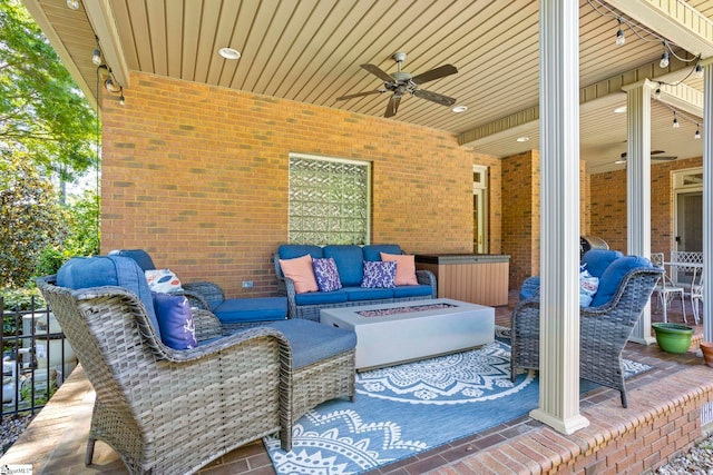view of patio / terrace featuring ceiling fan and an outdoor living space with a fire pit