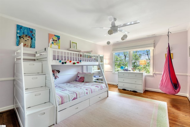 bedroom with ornamental molding, wood finished floors, baseboards, and a ceiling fan