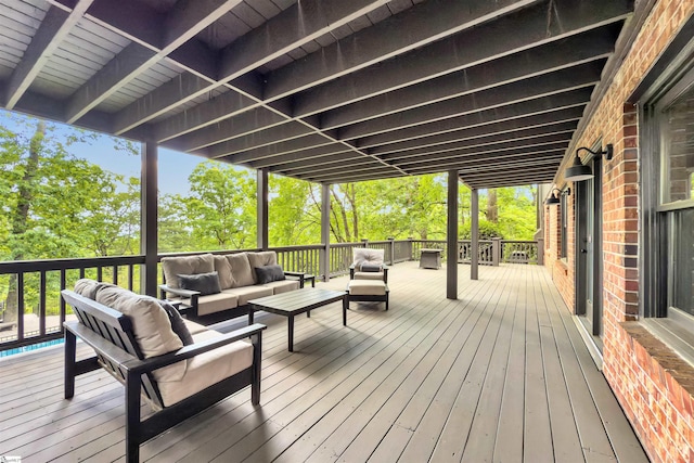 deck featuring outdoor lounge area and view of scattered trees