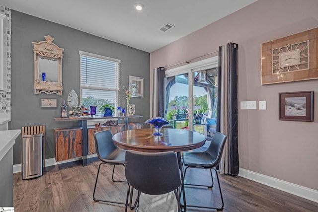 dining room featuring wood finished floors, baseboards, and recessed lighting