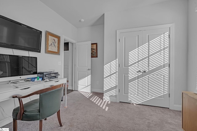 carpeted office space featuring baseboards