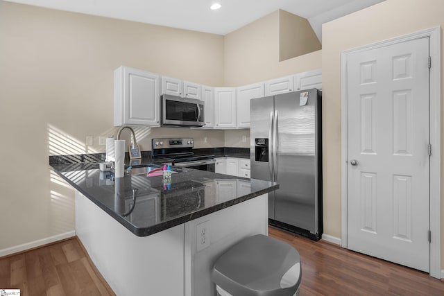 113 Glastonbury Dr, Greer, SC 29651 - kitchen featuring appliances with stainless steel finishes, a peninsula, white cabinets, baseboards, and recessed lighting