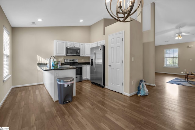 113 Glastonbury Dr, Greer, SC 29651 - kitchen featuring stainless steel appliances, dark countertops, a peninsula, baseboards, and dark wood finished floors