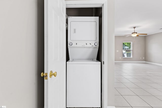 46 Ridgestone Cir, Mauldin, SC 29662 - clothes washing area with stacked washing machine and dryer, light tile patterned floors, a ceiling fan, and baseboards