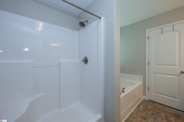 full bathroom featuring a shower and a garden tub