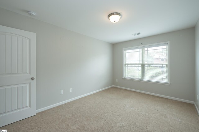 carpeted spare room with baseboards
