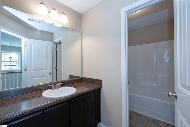 bathroom featuring vanity and shower / tub combination
