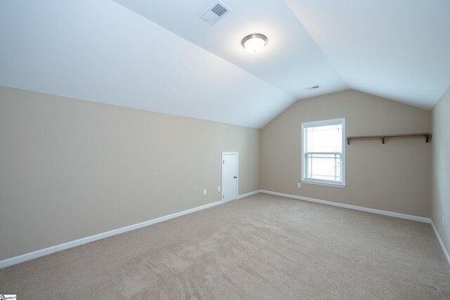 bonus room with lofted ceiling, carpet floors, and baseboards