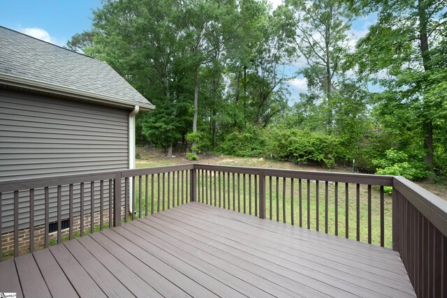 wooden terrace with a lawn