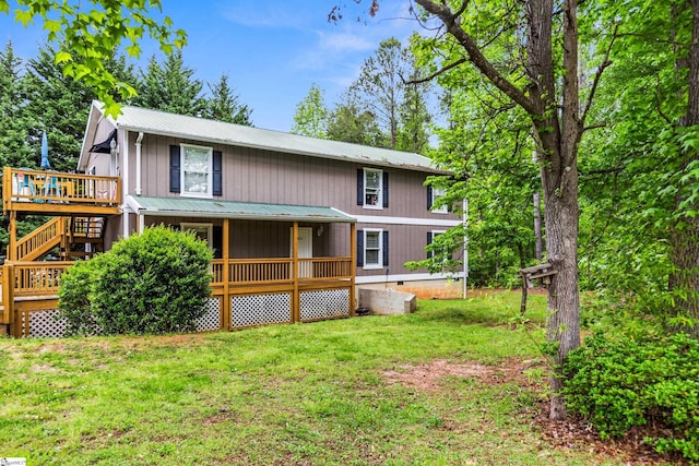 421 Wood Rd, Taylors, SC 29687 - view of front of house with metal roof, a front lawn, a deck, and a porch