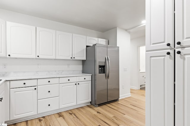 421 Wood Rd, Taylors, SC 29687 - kitchen featuring stainless steel fridge, light wood-style floors, white cabinets, and baseboards