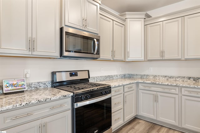 201 Rosecroft Dr, Easley, SC 29642 - kitchen featuring stainless steel appliances, light wood-style flooring, and light stone counters