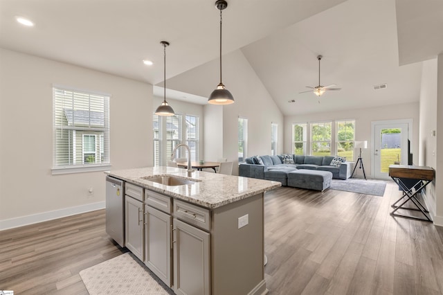 201 Rosecroft Dr, Easley, SC 29642 - kitchen with a sink, stainless steel dishwasher, light wood-style flooring, baseboards, and light stone counters