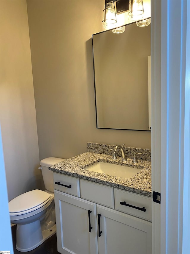 half bath with vanity and toilet