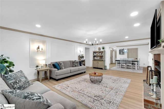 118 Briar Patch Rd, Anderson, SC 29621 - living area with ornamental molding, recessed lighting, a chandelier, light wood finished floors, and a brick fireplace