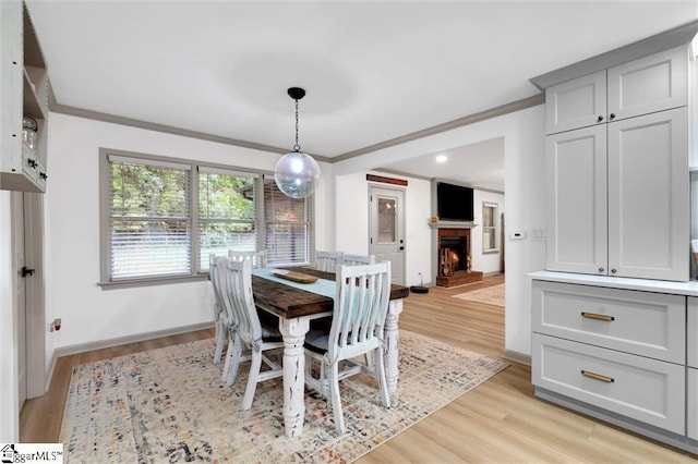 118 Briar Patch Rd, Anderson, SC 29621 - dining space with ornamental molding, a lit fireplace, light wood-style flooring, and baseboards