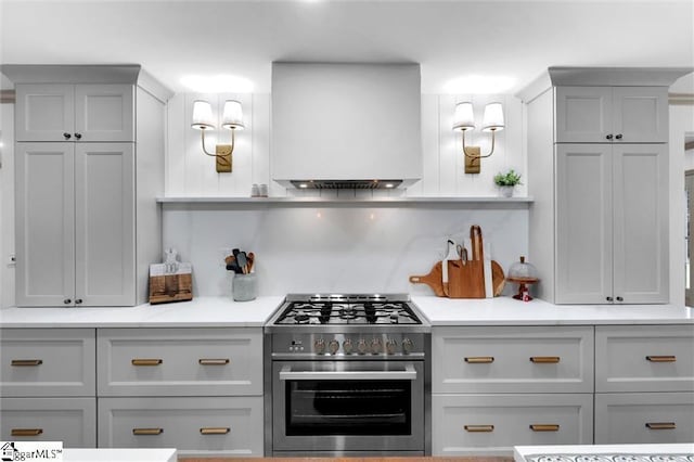 118 Briar Patch Rd, Anderson, SC 29621 - kitchen featuring high end stove, light countertops, wall chimney range hood, gray cabinets, and tasteful backsplash