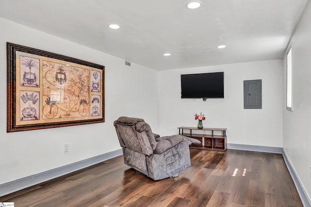 sitting room with electric panel, dark wood-style flooring, recessed lighting, and baseboards