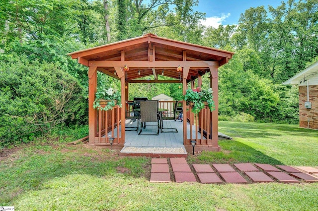 view of grassy yard featuring a gazebo and a wooden deck