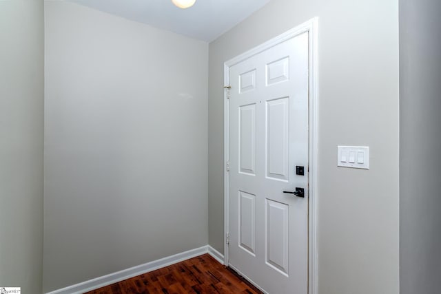 entryway featuring dark wood-style flooring and baseboards