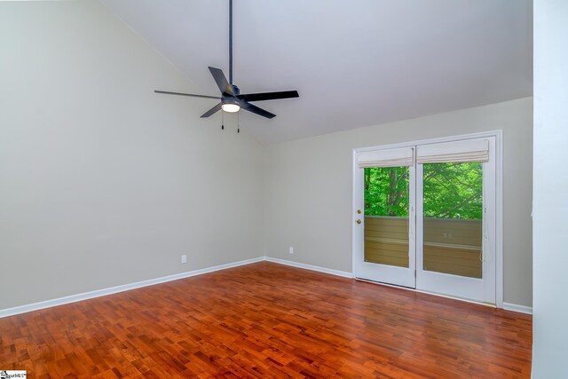 empty room featuring lofted ceiling, a ceiling fan, wood finished floors, and baseboards