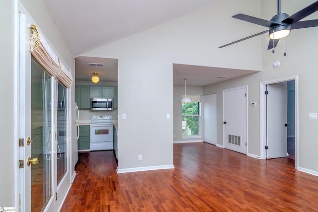 unfurnished living room with high vaulted ceiling, dark wood-type flooring, ceiling fan, and baseboards